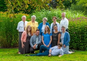 Grandmother posing with her children and grandchildren in the scenic Public Gardens in Halifax, capturing a multi-generational family moment surrounded by lush greenery and vibrant flowers.