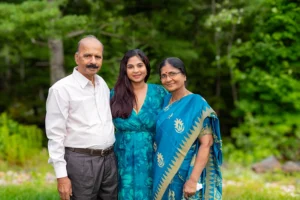 Grandparents posing with their daughter in a beautiful outdoor setting at a Family Portrait Studio, captured in a heartwarming family moment surrounded by nature.