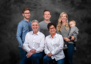 Grandparents posing with their daughter, who is holding their baby boy, captured in a warm and loving family moment in a Family Portrait Studio.
