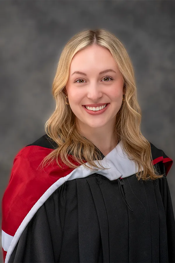 Saint Mary's University (SMU) Bachelor of Arts graduate wearing official white-lined academic hood in a Halifax studio.